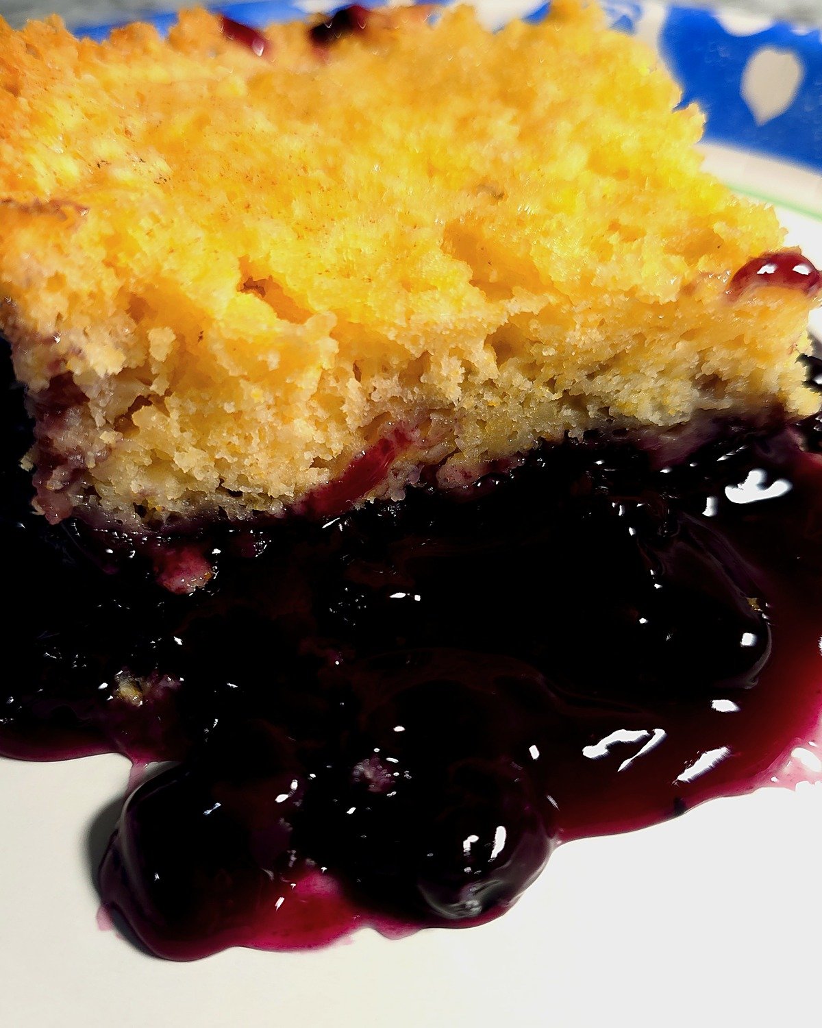 Close-up of blueberry lemon dump cake showing the soft, spongy cake layer over blueberry filling