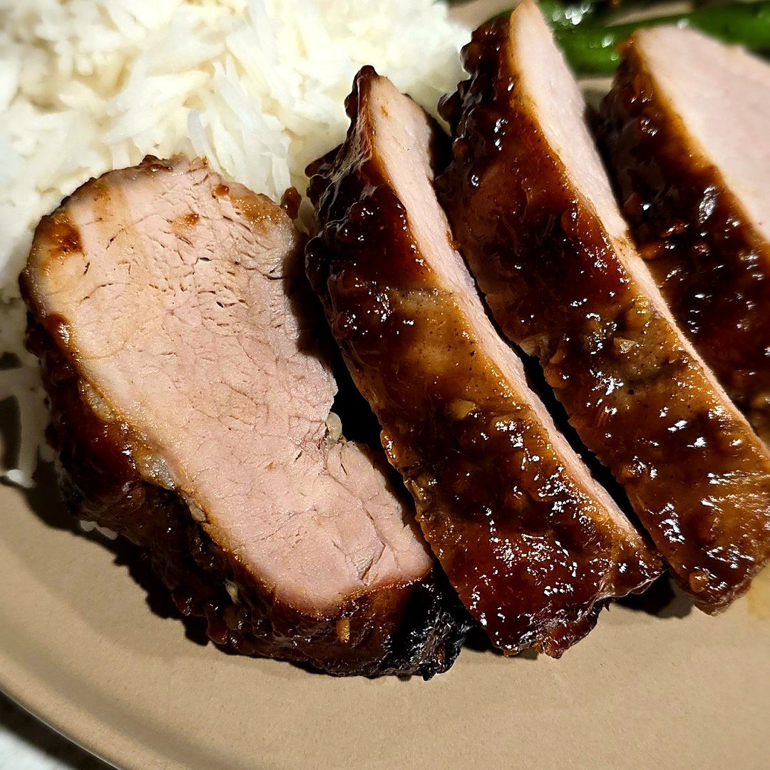 Sliced char siu pork tenderloin with sticky glaze, served with rice and green beans