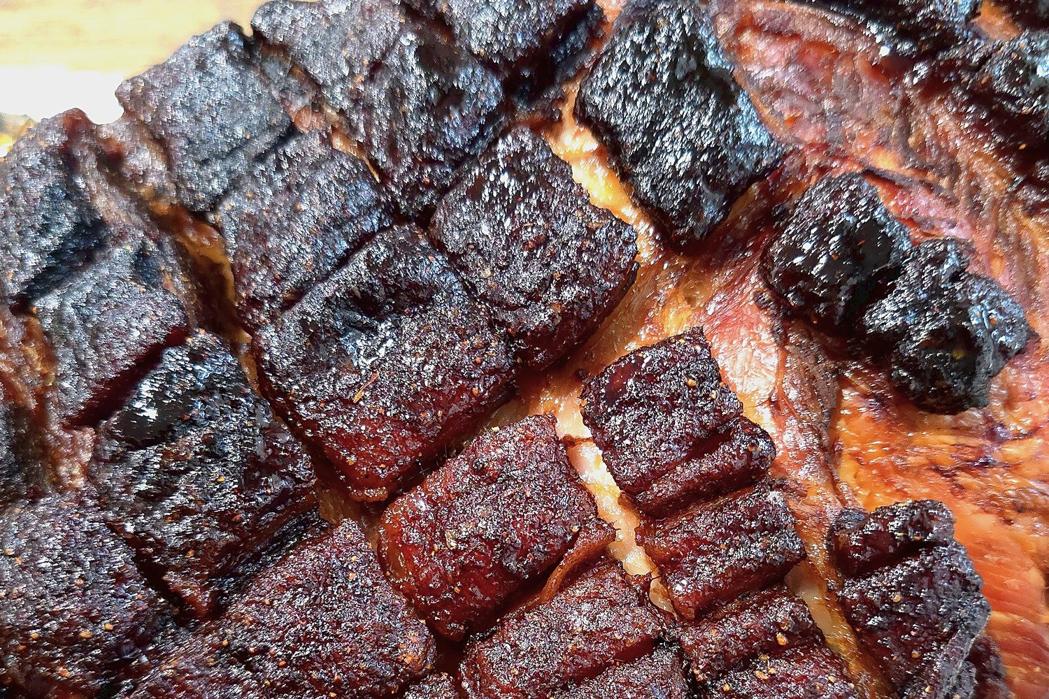 Close-up of the crispy, caramelized bark on a pork butt